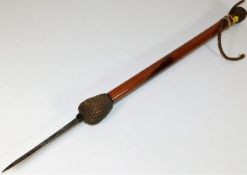 A hand held flicker cane with concealed locking bl