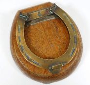 A Victorian brass horseshoe door knocker