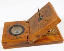 A 19thC. Chinese walnut pocket sundial, compass &