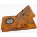 A 19thC. Chinese walnut pocket sundial, compass &