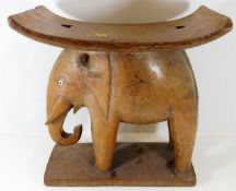 An early 20thC. carved elephant seat 17.25in wide