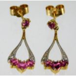 A pair of 9ct gold drop earrings set with ruby & d