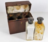 A leather scent bottle set with silver topped bott