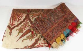 A large antique embroidered throw with paisley pri