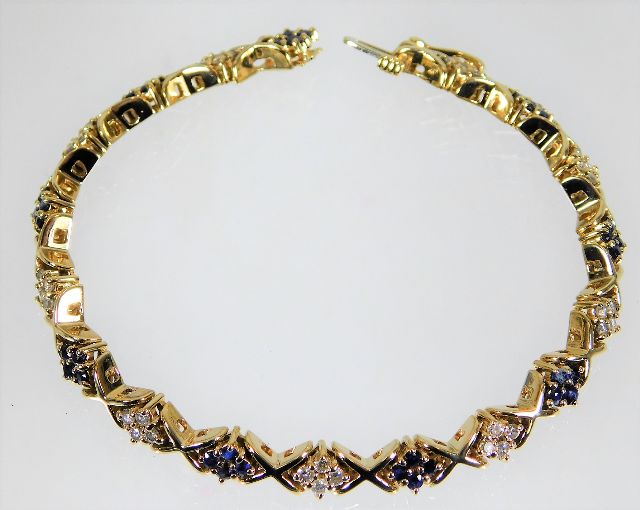A 14ct gold diamond & sapphire bracelet 20.5g 7.5i