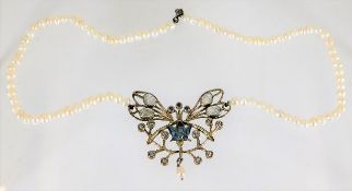 A pearl necklace set with white metal butterfly de