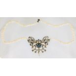 A pearl necklace set with white metal butterfly de