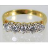 An 18ct gold ring set with five diamonds of approx