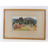 A framed unsigned watercolour depicting haystacks