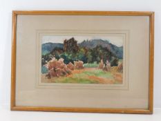 A framed unsigned watercolour depicting haystacks