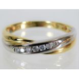 A 9ct two colour gold ring set with 0.15ct diamond