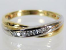 A 9ct two colour gold ring set with 0.15ct diamond