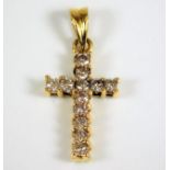 An 18ct gold cross set with diamonds of 0.25ct 1g