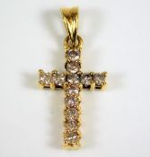 An 18ct gold cross set with diamonds of 0.25ct 1g