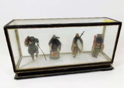 A cased set of four Chinese figures 9in long x 4.7