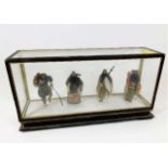 A cased set of four Chinese figures 9in long x 4.7