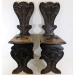 A 19thC. pair of carved oak hall chairs