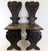 A 19thC. pair of carved oak hall chairs