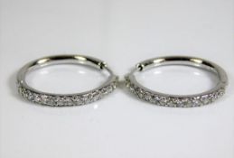 An 18ct white gold pair of earrings set with diamo