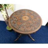 A 19thC. pedestal table with carved top with centr