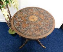 A 19thC. pedestal table with carved top with centr