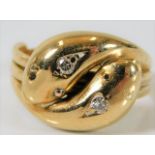 A 19thC. yellow metal double snake ring, tests as