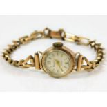 A 9ct gold cased watch with metal lined strap 10.5