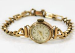 A 9ct gold cased watch with metal lined strap 10.5
