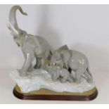 A large elephant figure group by Lladro with stand