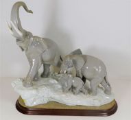 A large elephant figure group by Lladro with stand