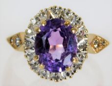A 9ct gold ring set with amethyst & 0.16ct of diam