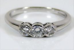 An 18ct white gold trilogy ring set with approx. 0