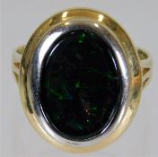 A 9t gold ring set with dark green stone with whit