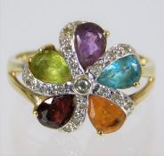 A 9ct gold ring set with diamonds & mixed stones 3