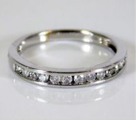 An 18ct white gold half eternity ring set with 0.2