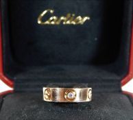 An 18ct rose gold Cartier Love ring set with three
