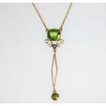 A 9ct gold pendant necklace set with peridot & pea