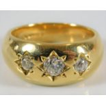 An 18ct gold three stone gypsy style ring set with
