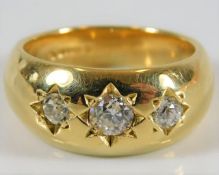An 18ct gold three stone gypsy style ring set with