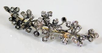 A 9ct white gold organic style diamond brooch, one