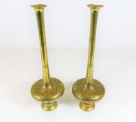A pair of tall brass Islamic vases