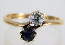 An 18ct gold crossover ring set with sapphire & o.