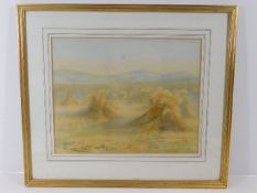 A framed watercolour depicting haystacks within su