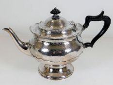 A Mappin & Webb footed teapot with hammered effect