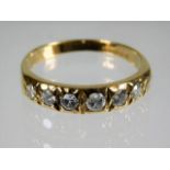 An 18ct gold ring set with seven diamonds of appro