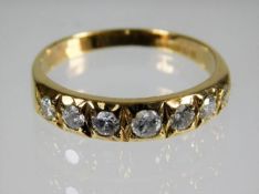 An 18ct gold ring set with seven diamonds of appro