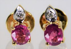 A pair of 18ct gold earrings set with ruby & diamo