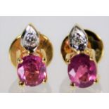 A pair of 18ct gold earrings set with ruby & diamo