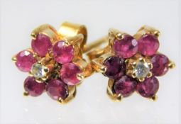 A pair of 9ct gold ruby & diamond daisy style earr