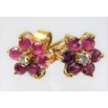 A pair of 9ct gold ruby & diamond daisy style earr